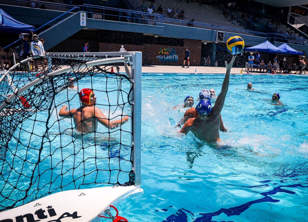 Water polo player shooting at goal during a match