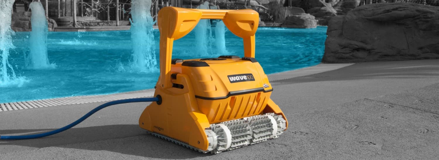 Dolphin Wave 100 robotic pool cleaner beside a resort pool