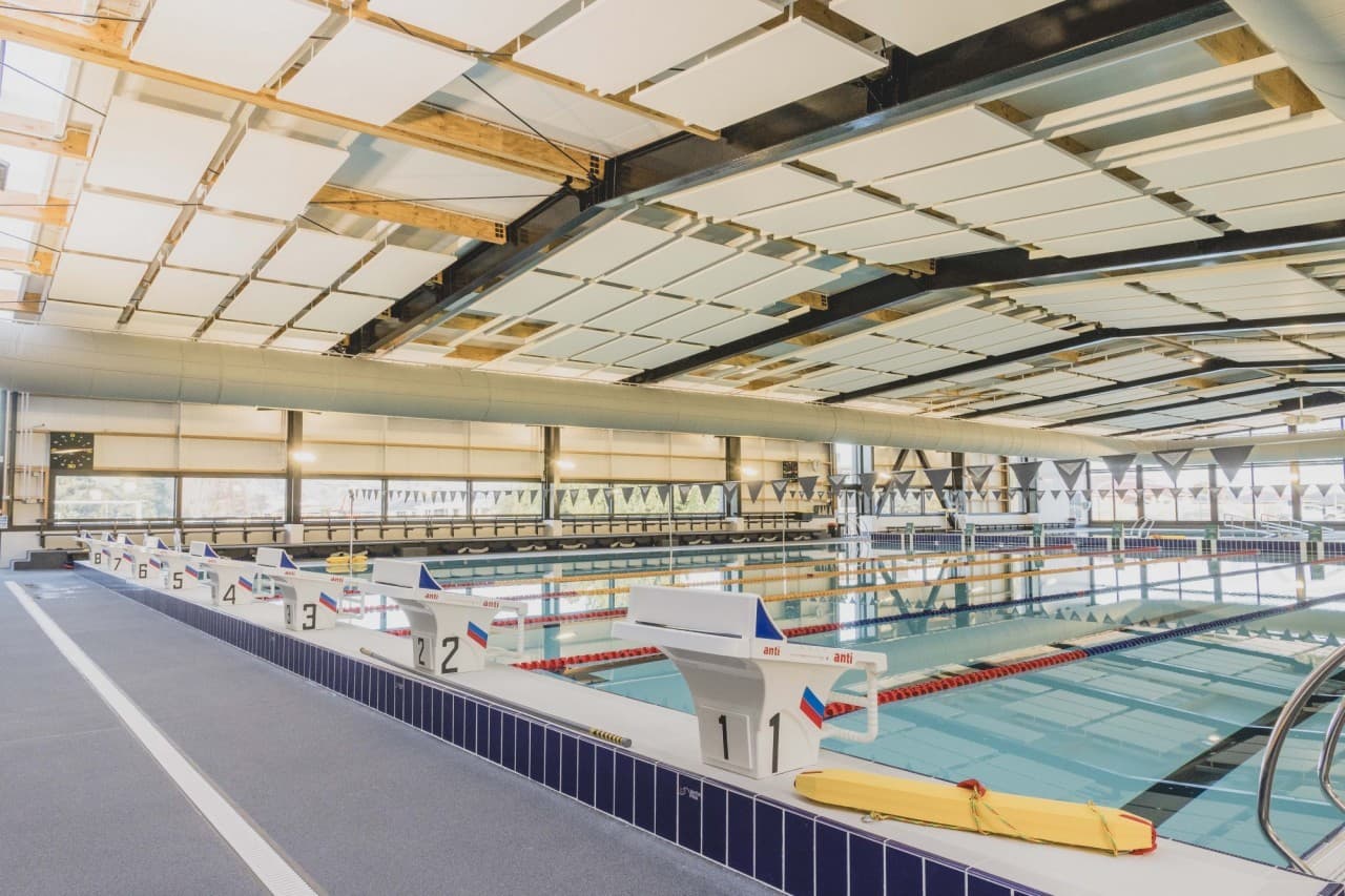 Indoor competition pool lined with ANTI numbered starting blocks
