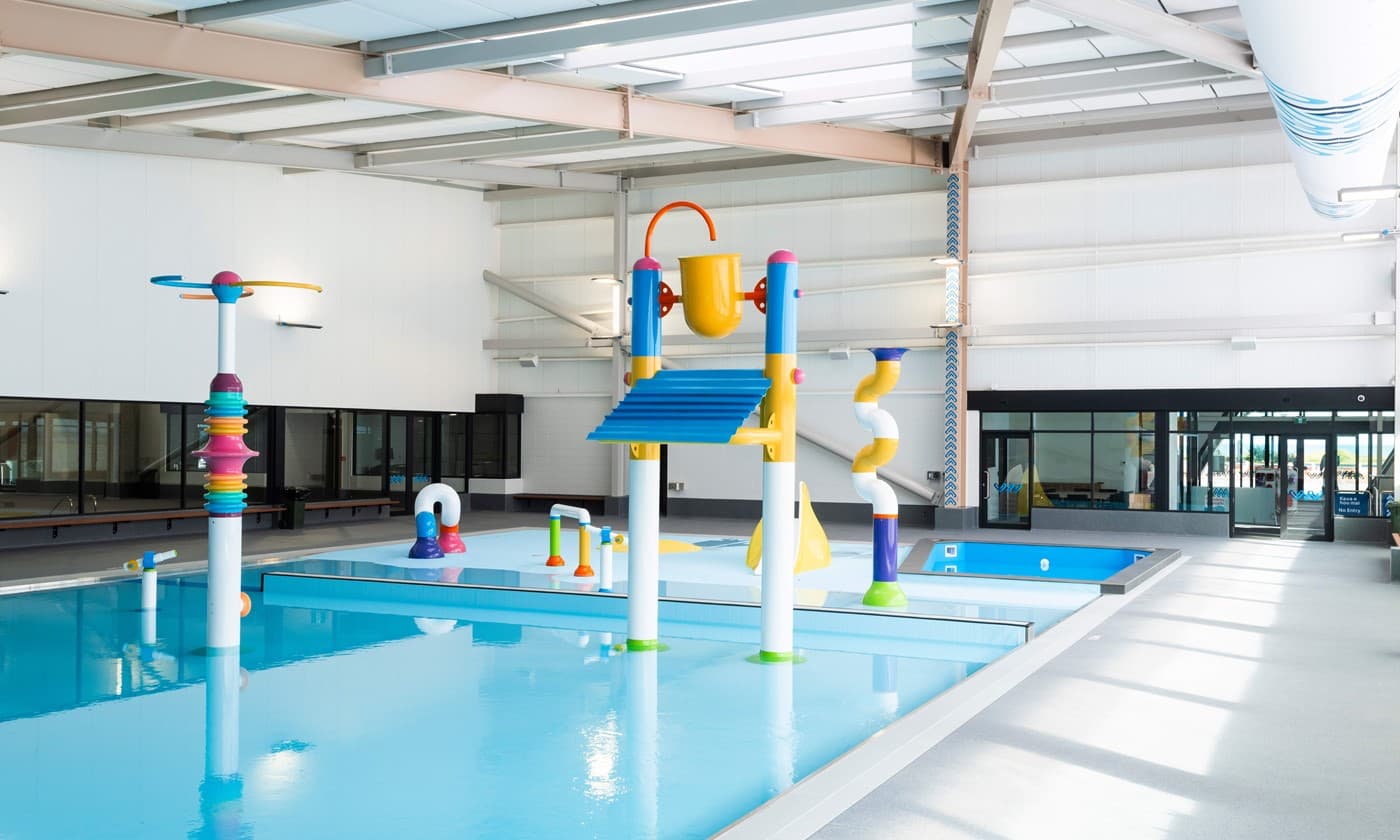 Indoor splash pad with colourful interactive water play features